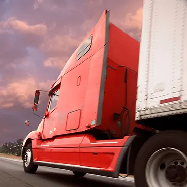 red transport truck with a trailer